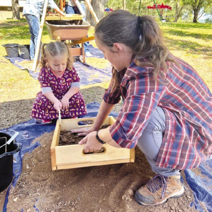 Texas Historical Commission staff and local families sift for archeological artifacts at Archeology Day’s mock excavation.