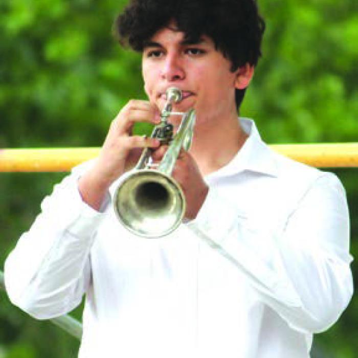 Gerardo Gomez played “America the Beautiful” and “Taps” on his trumpet Monday.