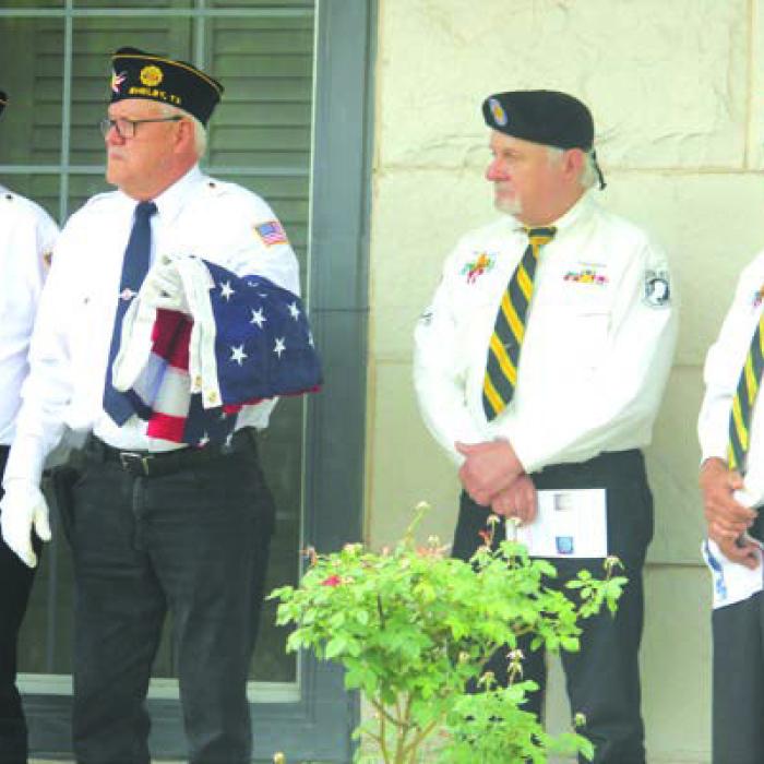 Lots of local veterans attended Monday’s ceremony, including a trio from Shelby American Legion Post 602, left, who oversaw the raising of a new flag at Koenig-Bellvill.