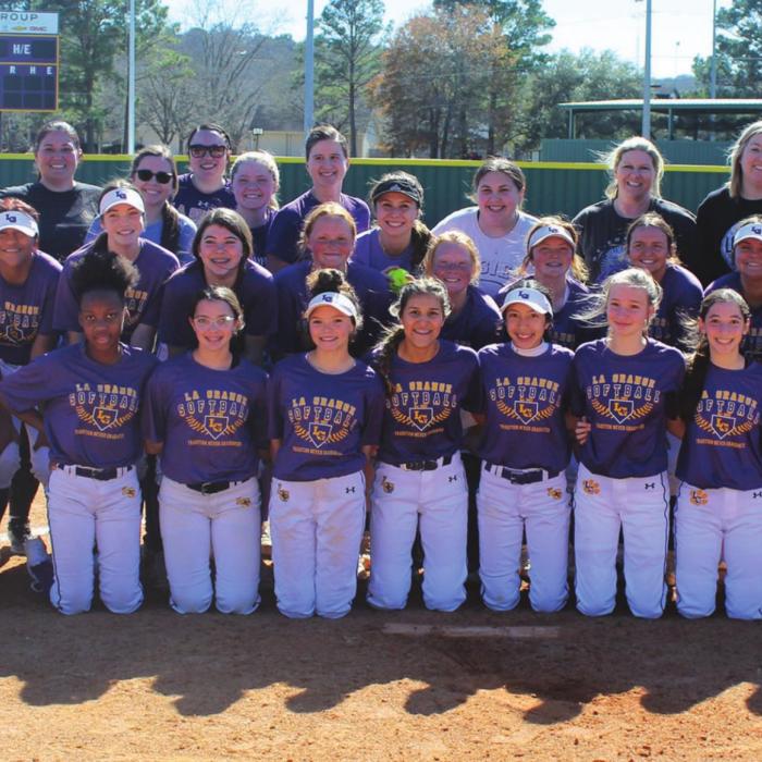 The members of the La Grange varsity and the alumni squad pose together after their annual scrimmage Saturday. Photo by Jeff Wick