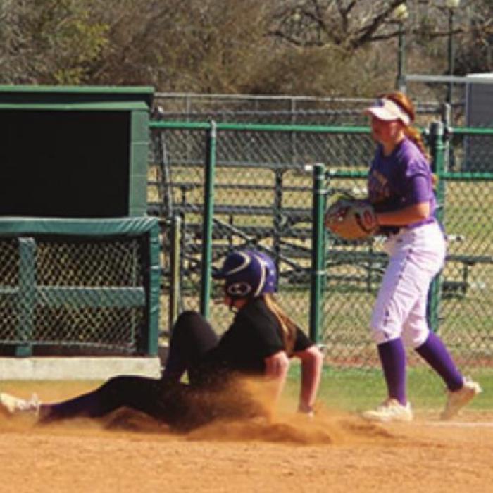 Above: Natalie Blackwell slides in safe at third after a triple for the alumni