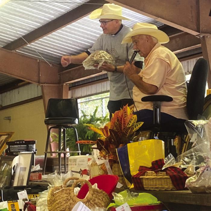 Father Steve Sauser and Rick Sodek auctioning items at Fayetteville St. John Feast.