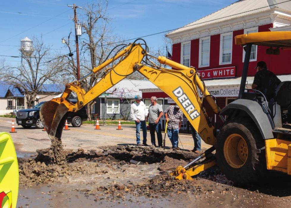 Workers dig a hole in SH 159 in Fayetteville on Wednesday to repair a six inch water line that burst. The incident caused the entire City to lose water pressure. A boil water notice has been issued. Photo by Andy Behlen