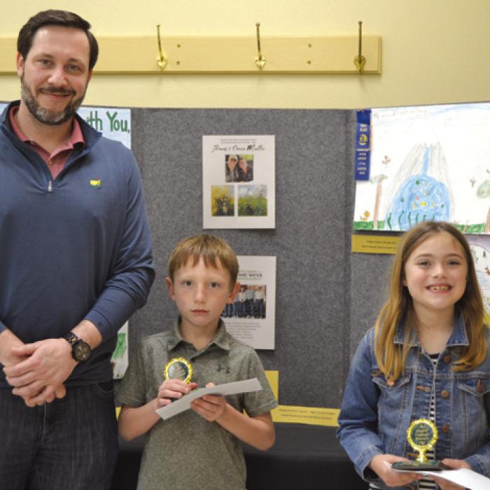 Poster Contest (Division 1; Grades K-2): Cason Peschke (Sacred Heart School) and Sylvia Shimek (Sacred Heart School); presenter: Bryan Minzenmeyer of Fayetteville Bank.