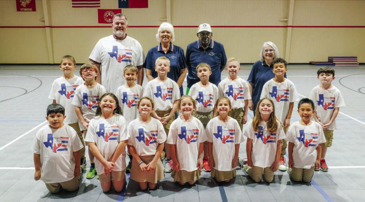 Fifteen second graders at Sacred Heart competed in the Fayette County Helpers jumpathon contest. They are pictured with (back, from left) P.E. Coach David Wicke, and FCH organizers Lisa Hayes, Jeff Kelly and Karen Forest.