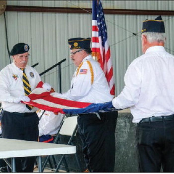 From left: Andy Janda of Vietnam Veterans of America Chapter 870, Scott Jones of the La Grange American Legion Post 102 and Bernard Svatek of Flatonia American Legion Post 94 conducted the flag folding ceremony at the Fayette County Flag Day Celebration on Sunday, June 14. Photo by Andy Behlen