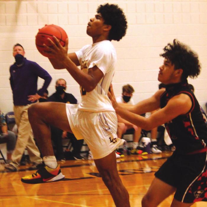 La Grange’s Bravion Rogers drives to the basket for part of his game-high 19 points Tuesday as Schulebburg’s Manny Herrera is on defense. Photos by Jeff Wick
