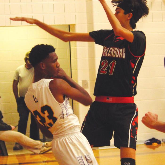 Schulenburg’s six-foot eight-inch Alex Lozano, right, proved to be a formidable matchup for La Grange. La Grange’s Brandon Scott, left, looks to make a pass.
