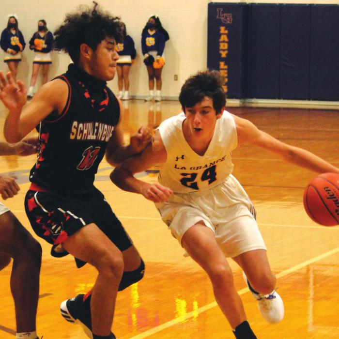 La Grange’s Jaxon Cooper drives to the basket in Tuesday’s game against the defense of Schulenburg’s Manny Herrera. Photo by Jeff Wick
