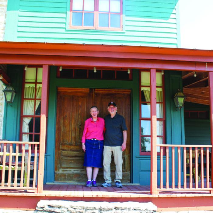 The Crawfords in front of home they have with restored, with the original doors still in place! Photo by Jessica Montez