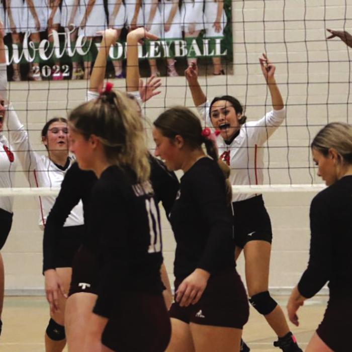 The members of the Schulenburg volleyball team celebrate a point Saturday in their playoff match as Thorndale players see their match slipping away. Photo by Audrey Kristynik