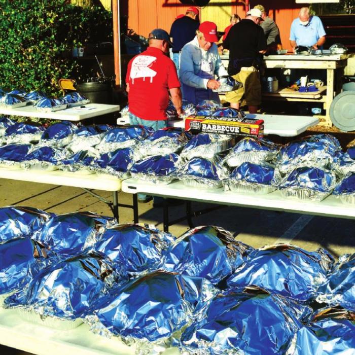 St. James Men’s Club Smokes Turkeys for Family Crisis Center