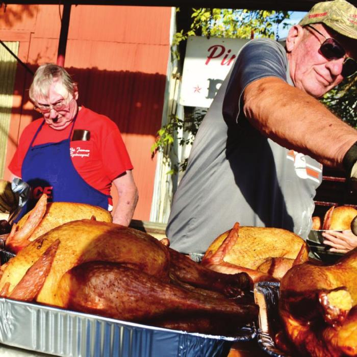 St. James Men’s Club Smokes Turkeys for Family Crisis Center
