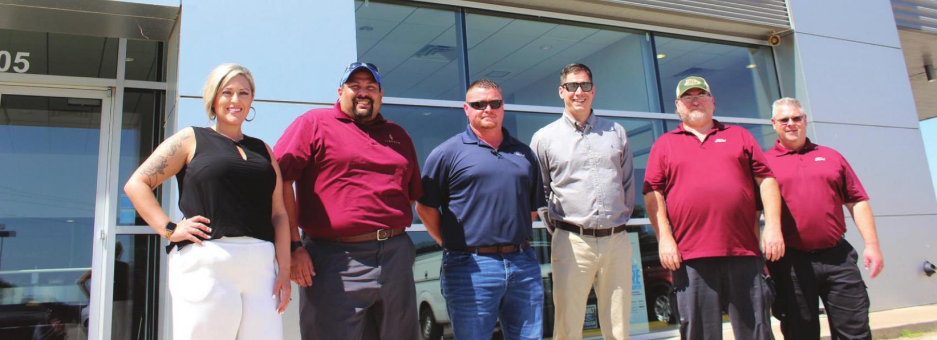 From left to right, the leadership team of Alpha One Ford in La Grange stand in front of the dealership’s new temporary sign – Natalie Hernandez (Internet and Marketing manager), Jose Molina (General Sales Manager), Ed Plumley (Sales manager), Shane Earls (Finance manager), Robby Nichols (Service Manager) and Mike Polasek (Body Shop Manager). Photo by Jeff Wick