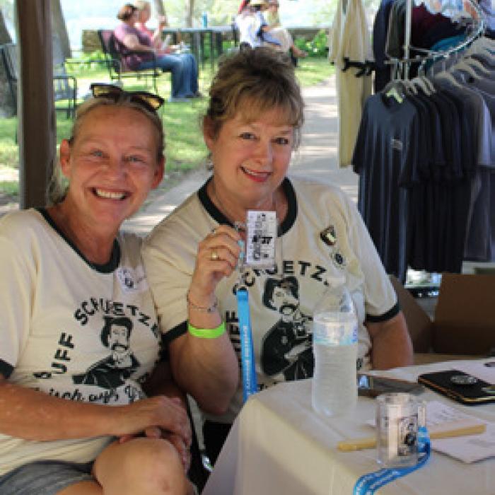 Volunteers Melissa Weltner and Diana Wilson give a cheer during their shift at the annual Bluff SchuetzenFest— an event impossible without Kreische Brewery &amp; Monument Hill’s volunteer team.