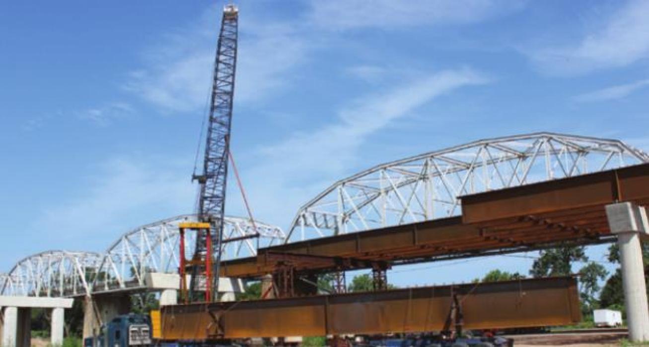 A new bridge is being built over the Colorado River in La Grange, but work has halted as supplies have run out.