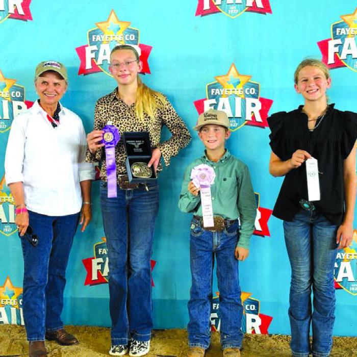 Overall High Point Winners, Junior, buckle sponsor in Memory of Emil Thomas, Elaine Thomas; Kennedy Kaspar, Rowdy Guenther and Harper Pittman.