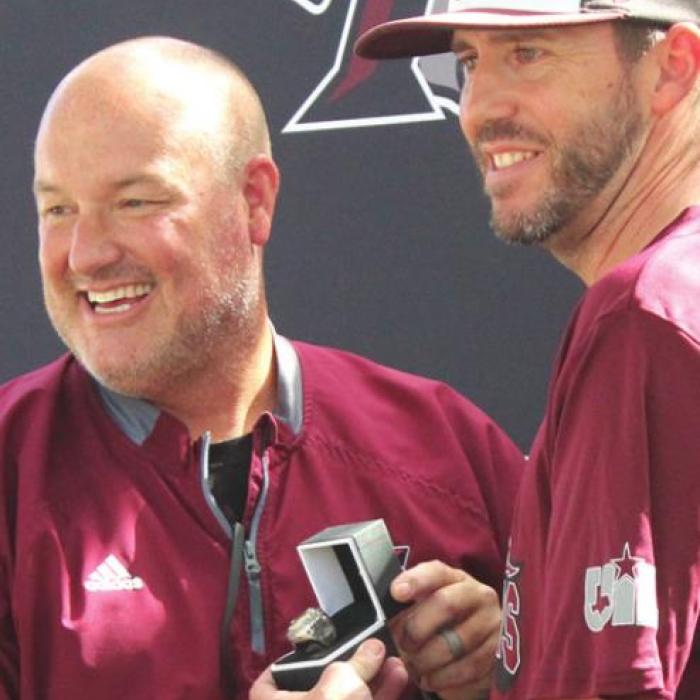 Fayetteville Superintendent Dr. Jeff Harvey presents the ring to head coach Clint Jaeger
