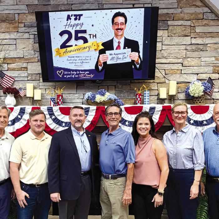 National Bank &amp; Trust, celebrating 138 years of community banking in La Grange, recently honored Michael Corker for 25 years of service on its Board of Directors. Board members and employees surprised Corker during the July board meeting to recognize his steadfast leadership and the lasting impact he has made on the bank, its employees, and the communities it serves.