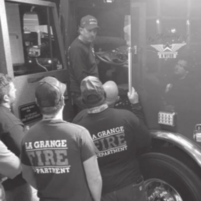 The members of the La Grange Fire Department tour, left, and then pose, right, by the new fire truck.