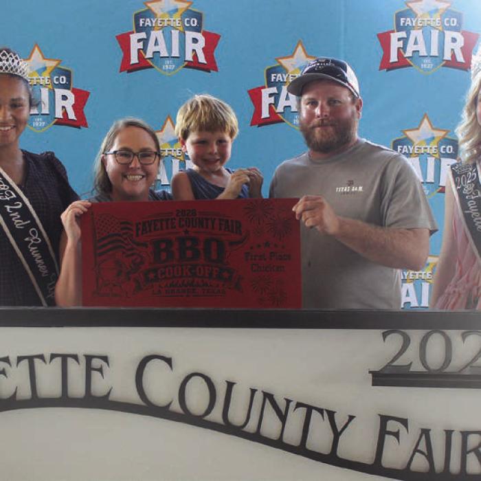 T-5 Cookers won first place chicken at Saturday’s Fayette County Fair Bar-B-Q Cook Off. Left to right 2025 Queen second runner-up Keanna Henderson, Camden Tabbert holding Grayson Tabbert, Dustin Tabbert and 2025 Fair Queen Hailey Janish.