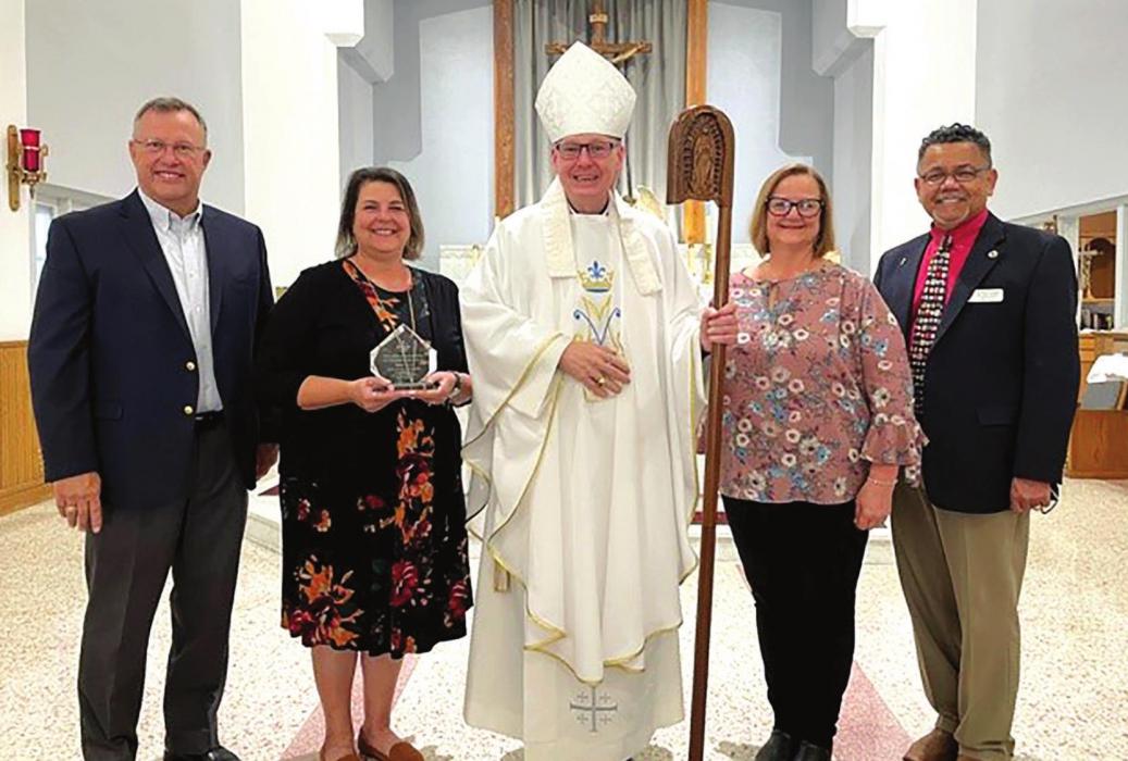 St. Rose of Lima Catholic School Teacher Donna Kunz received the Texas Conference of Catholic Bishops’ Elementary Teacher of the Year Award last Thursday. Pictured (from left) are David Schmidt, President of the Victoria Diocese School Advisory Council, Kunz, the Most. Rev. Brendan Cahill, Bishop of the Victoria Diocese, St. Rose School Principal Rosanne Gallia, and Dr. John Quary, Superintendent of Schools for the Victoria Diocese. Photo by Ashley Novosad/Diocese of Victoria