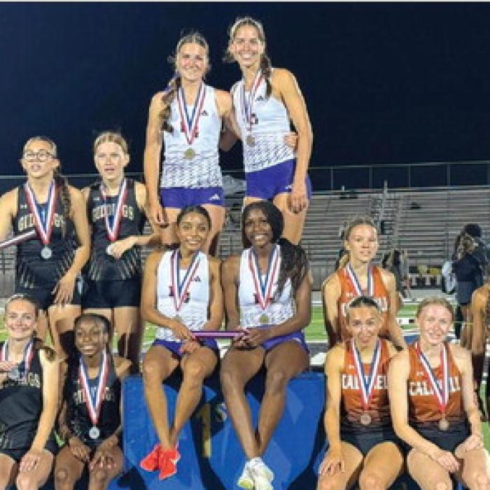 La Grange’s Diamond McKenzie, London Broussard, Kyndal Brawley and Macie Collier are atop the medal stand after winning the District 22-4A 4x400 relay Thursday.