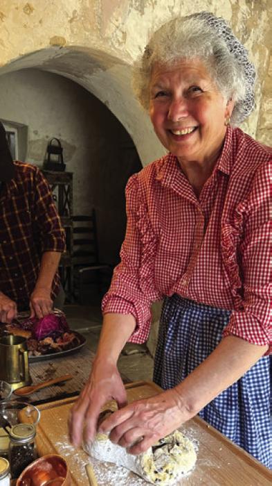 Volunteer Bobbie Nash prepares an Easter meal in the Kreische kitchen.