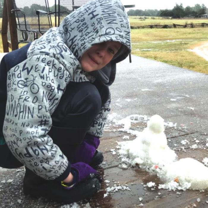 With school cancelled, Maddox Wick of La Grange was able to scrape together enough ice to put together a small snowman as sleet fell here Thursday afternoon.