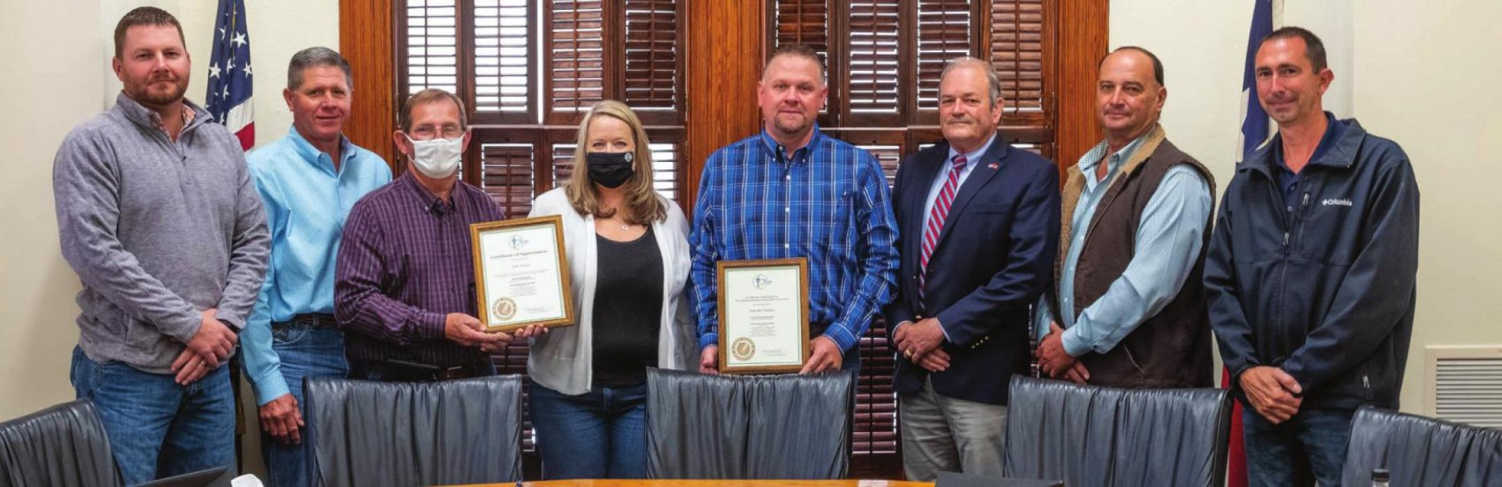 Rachel Hering of Keep Texas Beautiful presented awards to retired Pct. 4 Commissioner Tom Muras and the Fayette County Recycling Center for outstanding recycling efforts. Pictured (from left) are Pct. 4 Commissioner Drew Brossmann, Pct. 3 Commissioner Harvey Berckenhoff, Muras, Hering, Fayette County Recycling Center Manager Paul Zapalac, County Judge Joe Weber, Pct. 2 Commissioner Luke Sternadel and Pct. 1 Commissioner Jason McBroom. Photo by Andy Behlen