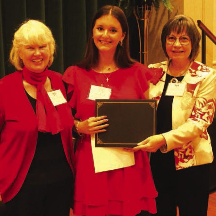 Amalia “Molly” Rorschach, center, was one of the Student Writing Showcase winners for her essay on Rozine Tilicek. Left is program MC Elota Patton. Right is LWV program coordinator Helen Niesner.