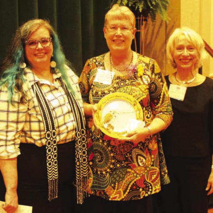 Brenda Lincke Fisseler, center was honored Sunday in the area of “Determination.” Introducing her was Dr. Rebecca Elder, left. Right is Janis Richardson President, League of Women Voters of South Central Texas.