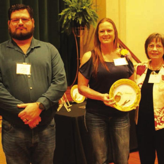 Sgt. Angela Lala was honored Sunday in the area of “Heroism.” Introducing her was Investigator Jeremy Castleberry, left. Right is LWV program coordinator Helen Niesner.