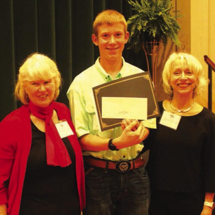 Gabriel Dotson, center, of Hallettsville, was one of the Student Writing Showcase winners for his essay on Hallettsville namesake Margaret Hallett. Left is program MC Elota Patton. Right is Janis Richardson President, League of Women Voters of South Central Texas.