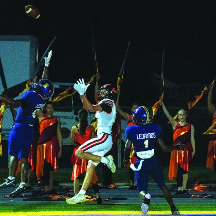 La Grange’s Dillan Johnson, left, and Trey Broussard, right, sandwich this Smithville receiver in the endzone and would deny a touchdown catch.