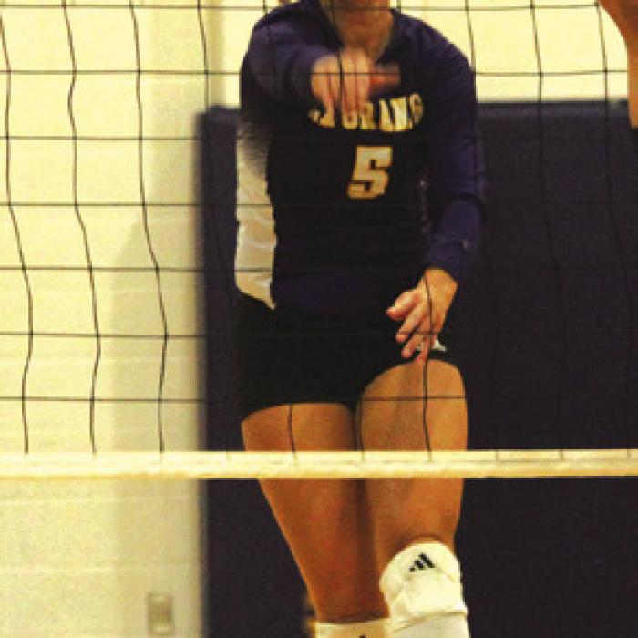 La Grange’s Campbell Cooper spikes a ball past a blocker earlier this season. Photo by Jeff Wick