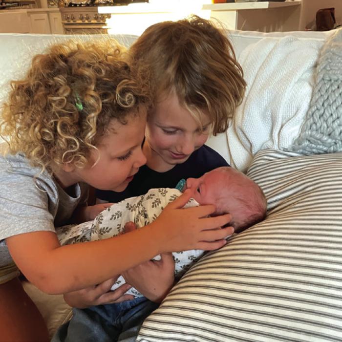 Big sister Hannah and big brother Benjamin meeting Daniel for the first time. He was the first of the triplets to come home.
