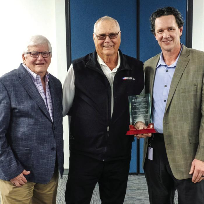 Region 13 Chairman Gary Barnett (left) and executive director Rich Elsasser (right) presented Erwin Sladek (center) with a plaque during the dedication last Thursday. Photo by Andy Behlen