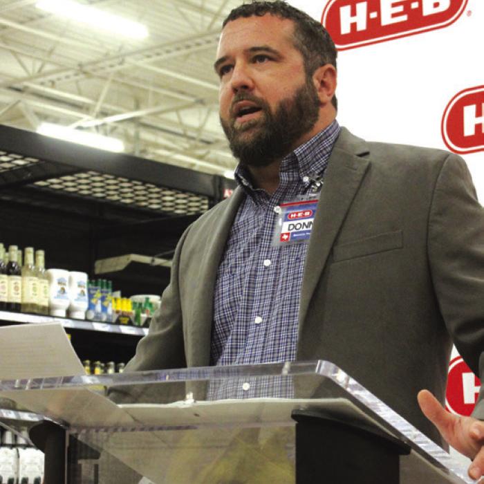 Store director Donnie Lowes talked to the crowd before the ribbon cutting.