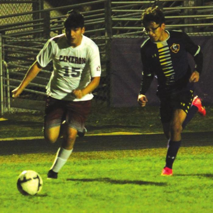 Above: La Grange’s Victor Soto races a Cameron player to the ball Tuesday.