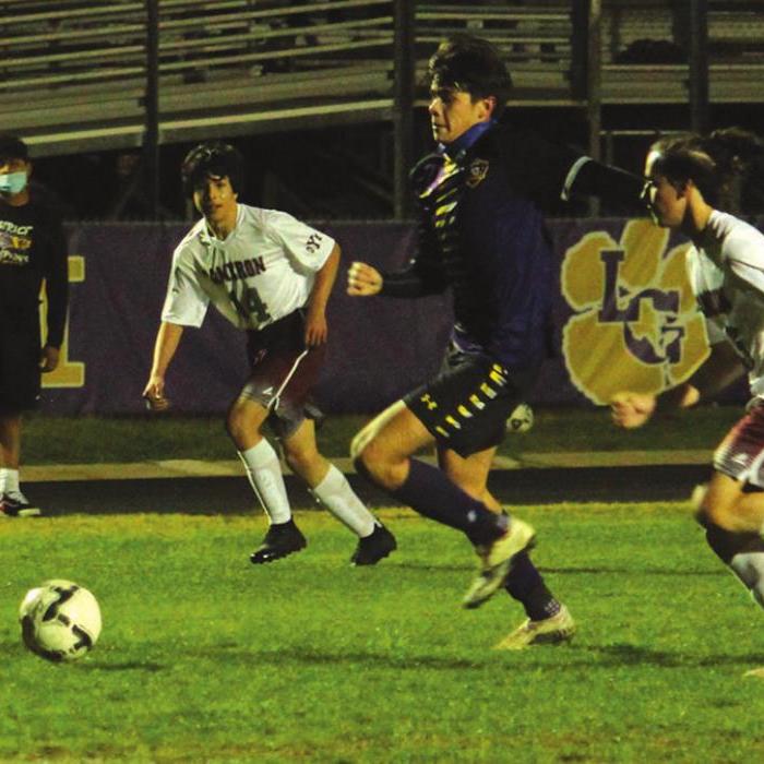 Below: La Grange’s Hector Orona beats a pair of Cameron players to the ball in action Tuesday. Photos by Jeff Wick