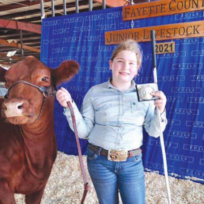 Rheagan Karisch and her exotic haired heifer Scarlett.