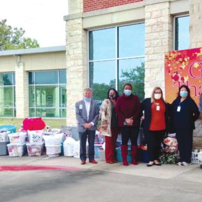 Pictured are Mark Kimball, president and CEO of St. Mark’s Medical Center and staff at St. Mark’s who helped coordinate the annual Thanksgiving food basket drive.