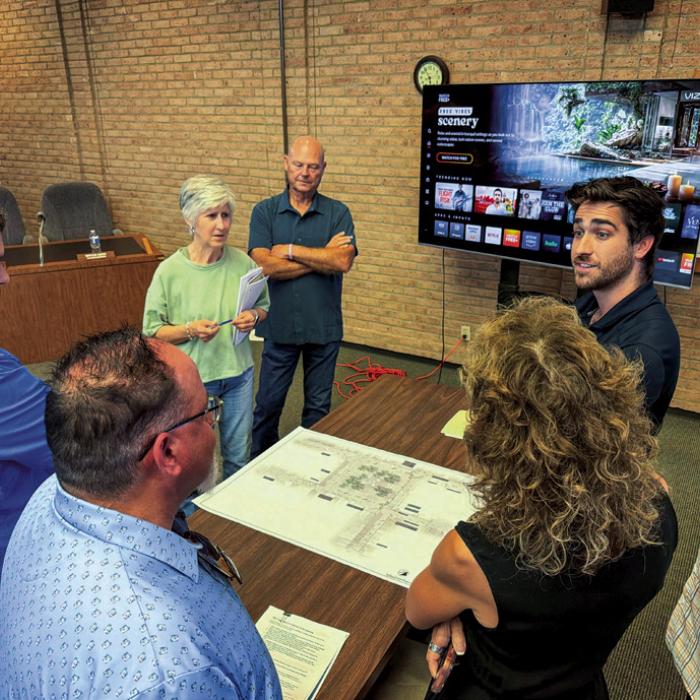 La Grange Main Street Manager Caleb Parks (top right) speaks with members of the public and the Council about the newest downtown parking design. Photo by Andy Behlen