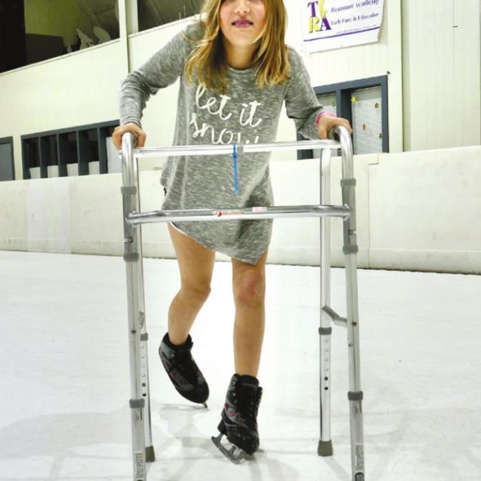 Jesus Ibarra leads Juan Sanchez as the two La Grange fifth graders scoot around the rink laid on the gym floor. And Kalyn Kasparek, a 4th grader from Katy who was in town visiting grandparents, charges ahead with the help of a Second Chance walker.