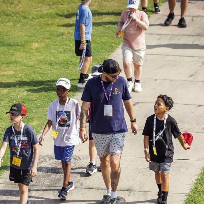 A counselor walks with some of the kids at Camp Periwinkle last week.