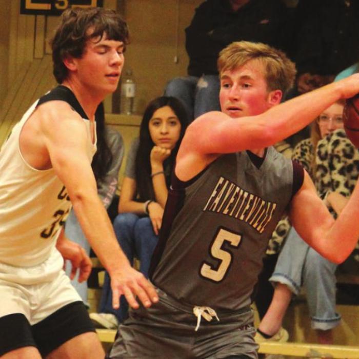 Fayetteville’s Logan Fritsch looks for an open pass against the defense of RT-C’s Hunter Schobel. Photo by Jeff Wick