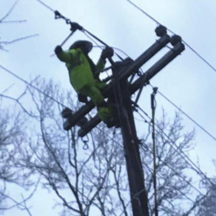 Lineman Royce Friemel is on a pole pulling wire to repair a downed power line in the Round Top area. (Photo credit: Apprentice Lineman Joey Jasek)