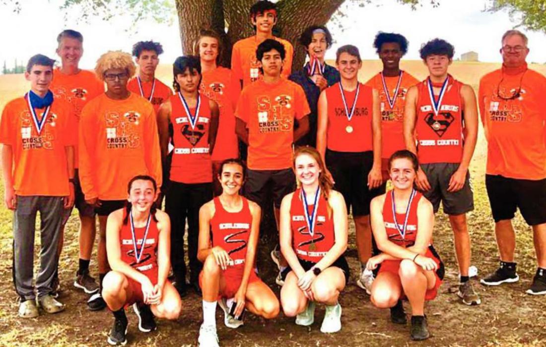 The Schulenburg cross country teams pose with their medals after Monday’s district meet in Shiner. Photo by Dave Oldham