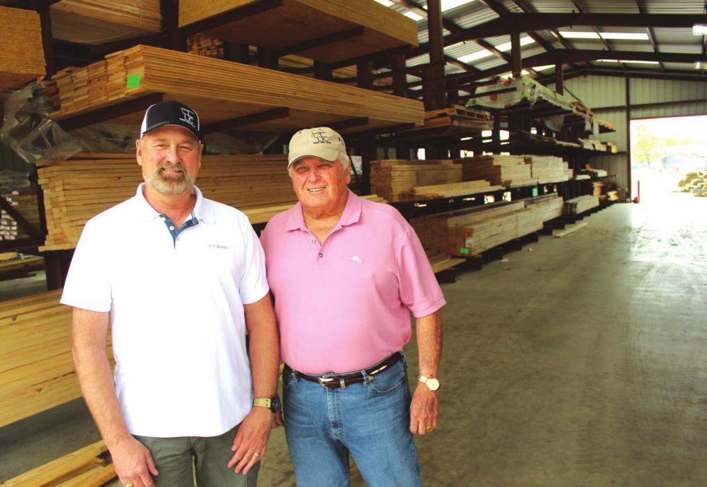 Left to right, Walt Jackson, Farmers Lumber Company General Manager, and Herb Janssen, President of Farmers Board of Directors, stand in one of the lumber supply building in La Grange, similar to one that’s going to be built behind Round Top Mercantile. Photo by Jeff Wick